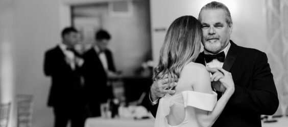black and white photo of father and daughter dancing at her wedding