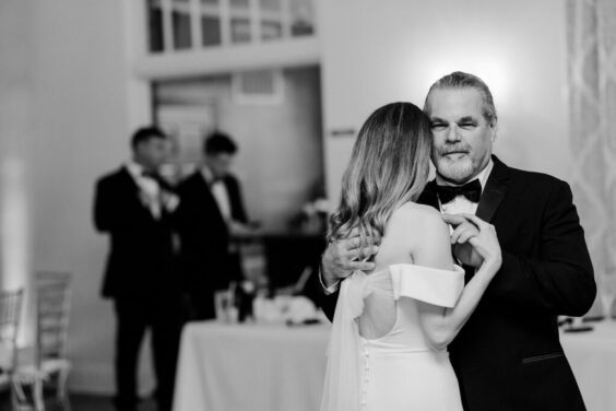 black and white photo of father and daughter dancing at her wedding